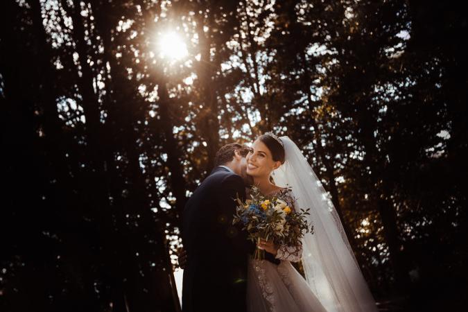 
	spouses kiss during sunset
