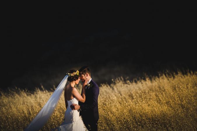 
	groom and bride pose at sunset
