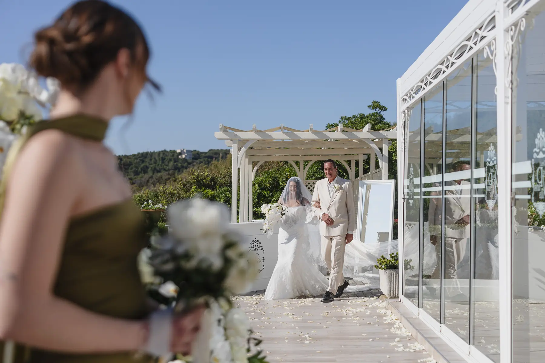 Bride escorted by her father to the terrace ceremony in Castiglioncello