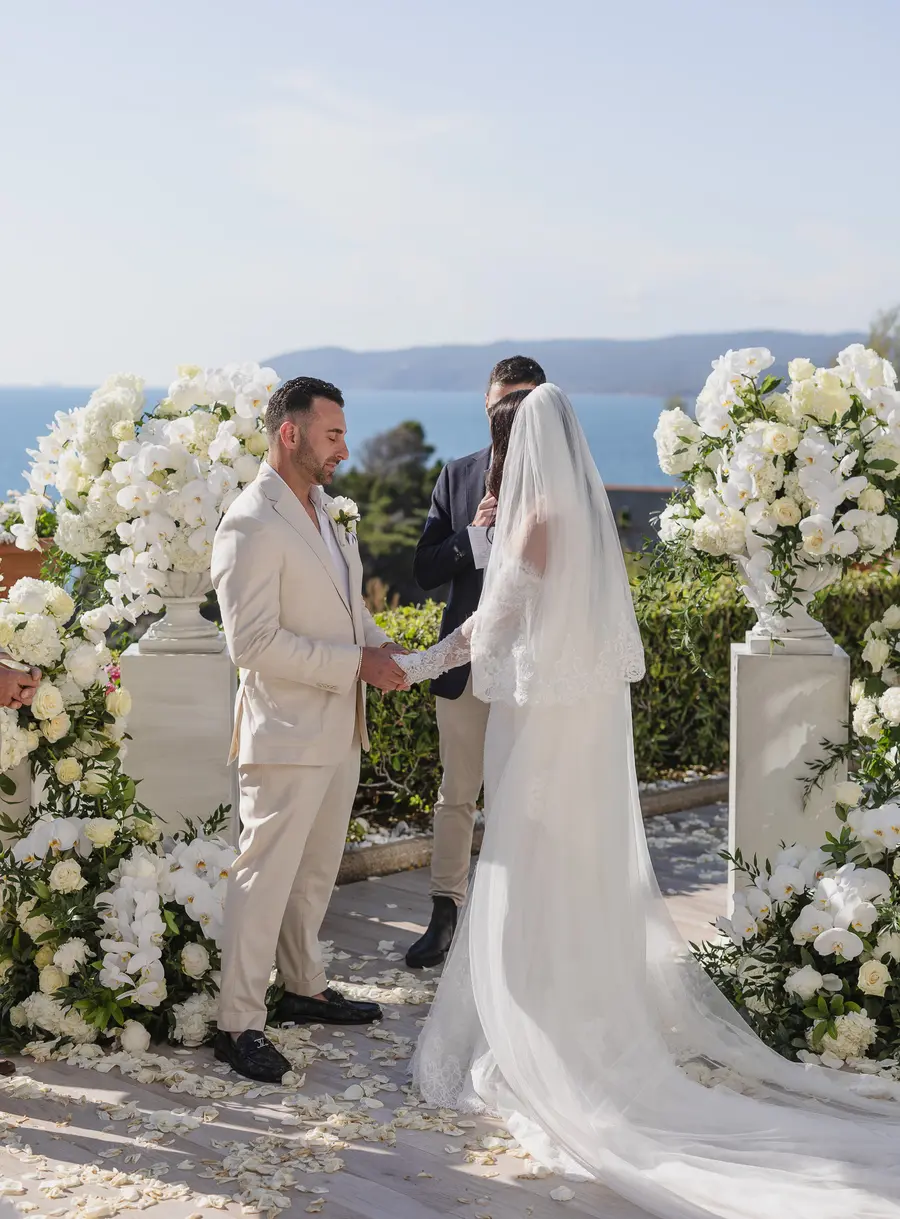 Couple holding hands during the terrace wedding ceremony at Villa Parisi