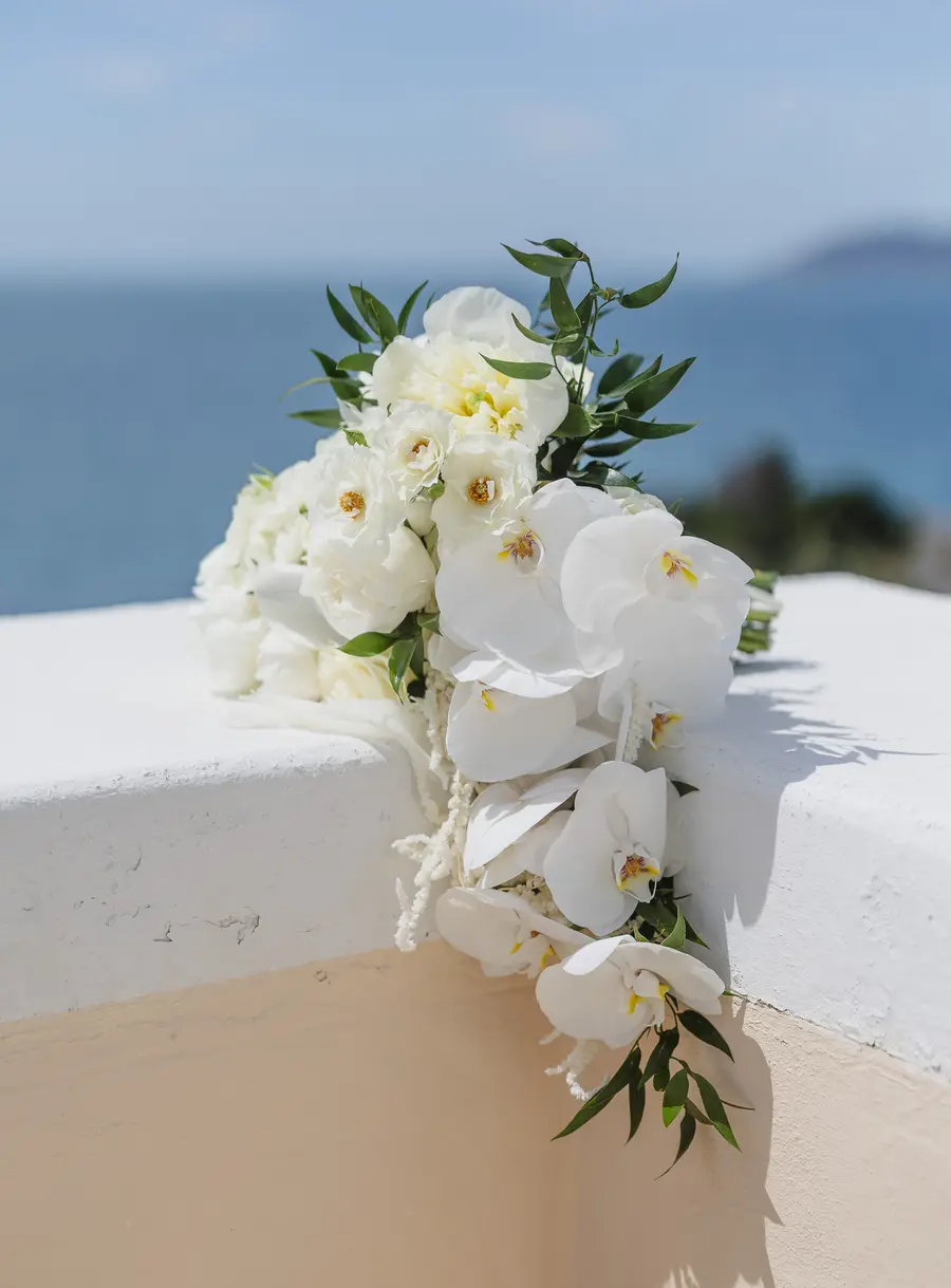 White orchid and peony bridal bouquet on a sea terrace in Castiglioncello