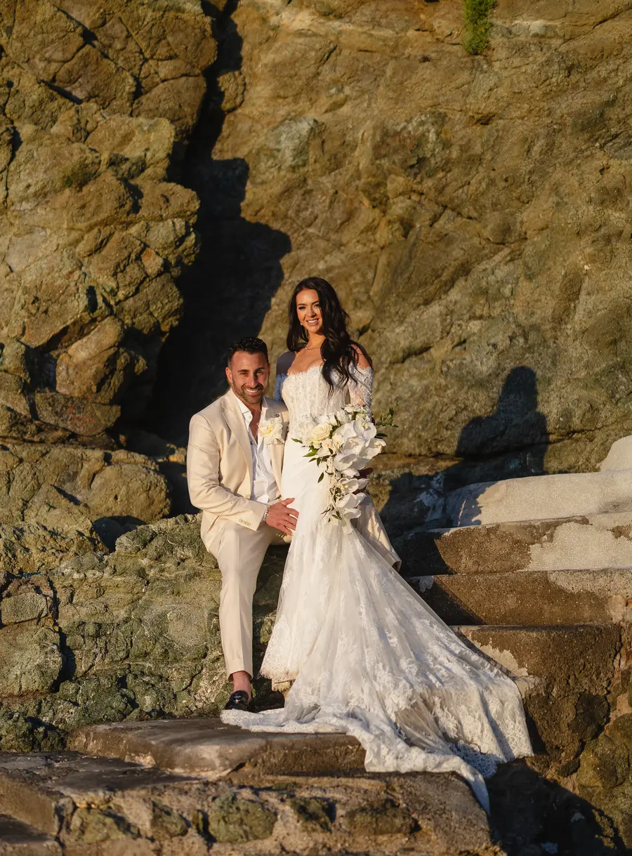 Smiling couple on the Castiglioncello cliff in golden sunset light