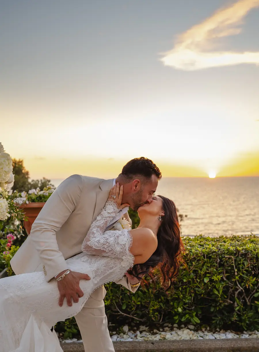Dip kiss on the terrace with the sun setting over the Tuscan sea
