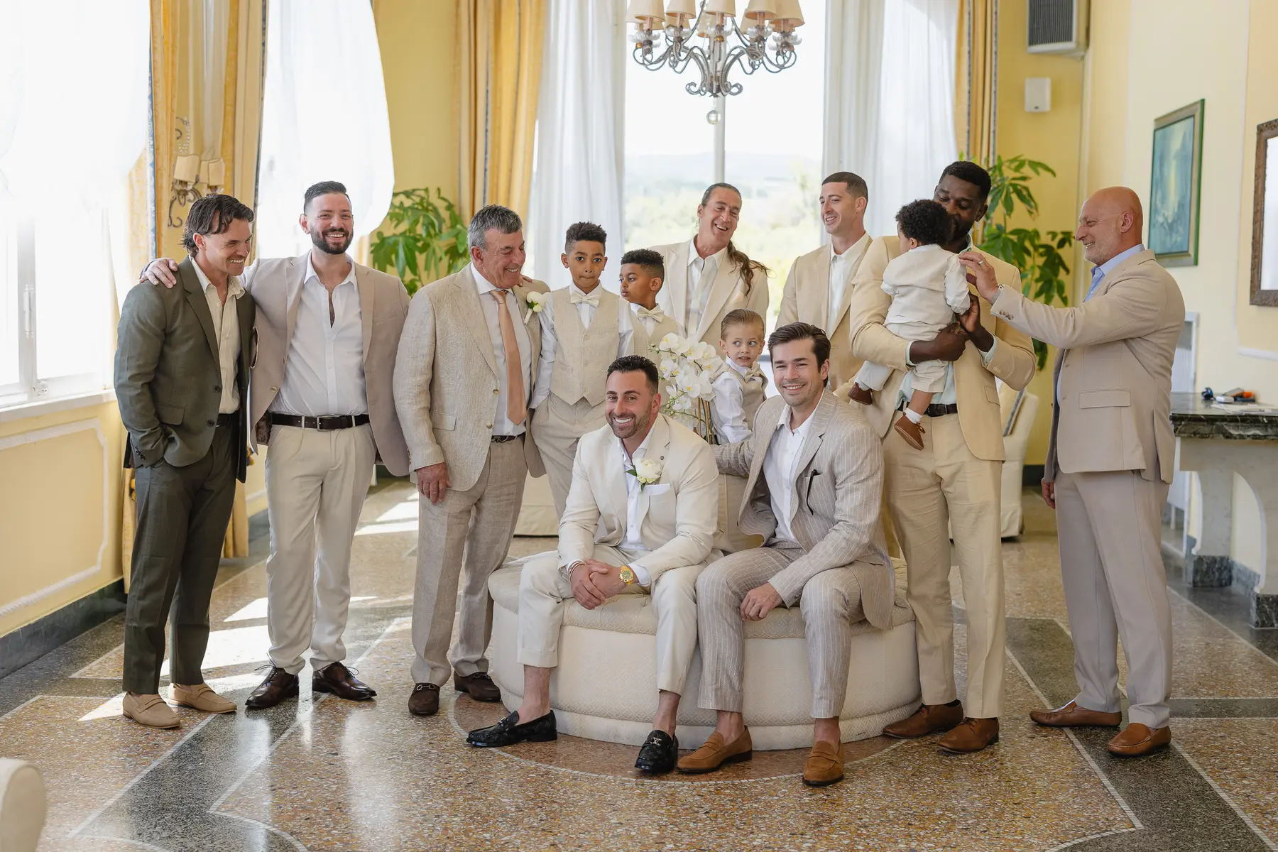 Groom with friends, family and children in beige suits before the wedding